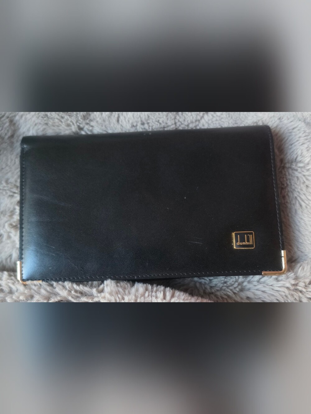 Dunhill Black Leather Wallet with Gold Accents offers a minimalist luxury design